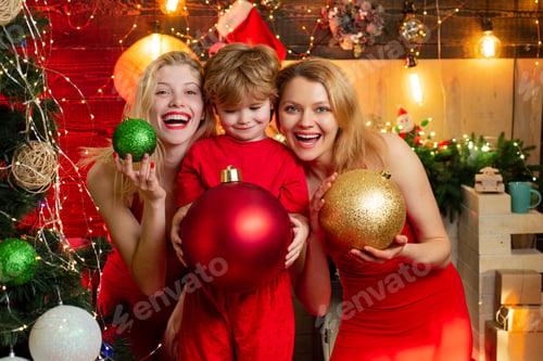 Preview: Excited Woman And Lovely Little Boy With Christmas Decoration Are Standing By The Christmas