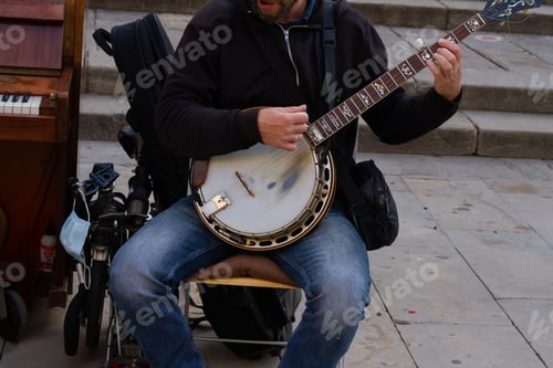 Preview: A Closeup Shot Of A Street Musician Playing The Bandurria