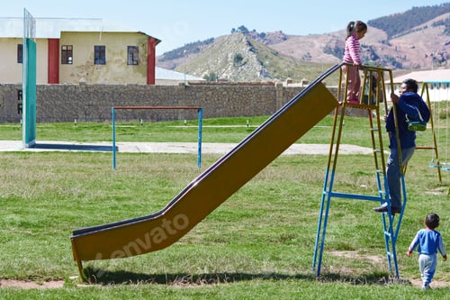 Preview: Native American Man With His Two Little Children On The Playground.