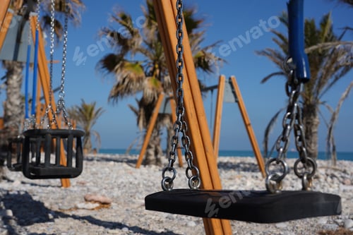 Preview: The Swings In The Sandy Beach And A Blue Clear Sky