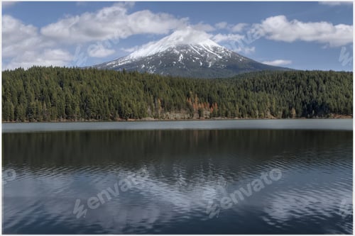 Preview: A Beautiful View Of A Mountain Peak Behind The Trees By A Calm Lake