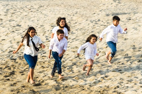 Preview: Children Running Along The Shore Of The Beach A Sunny Day