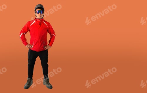 Vista previa: Full Length Portrait Of Smiley Hiker With Glasses And Helmet. Isolated On Orange Background