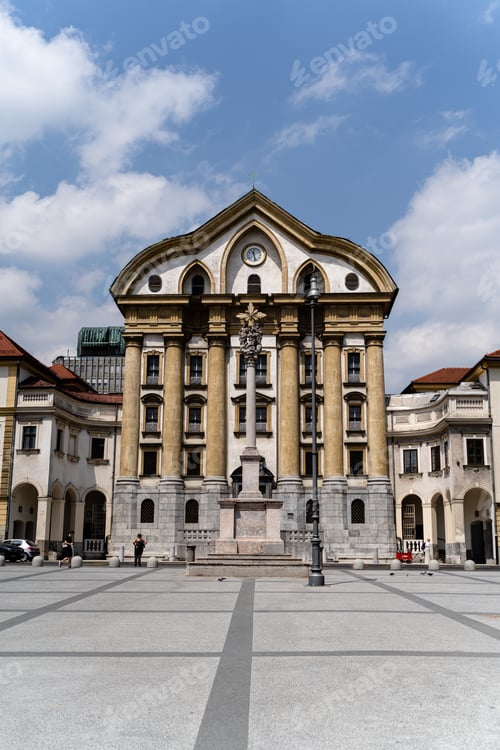Preview: A Vertical Shot Of A Beautiful Church Of The Holy Trinity In Ljubljana, Slovenia Under The Cloudy