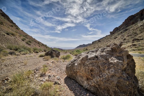 Preview: A Beautiful Shot Of A Rocky Pathway With Rocky Hills On Both Sides