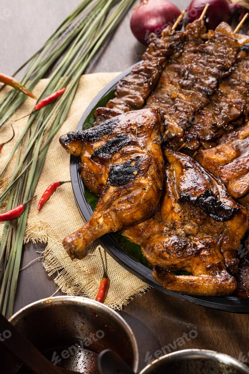 Preview: A Vertical Shot Of A Grilled Chicken Served With Delicious Pork And Kebab