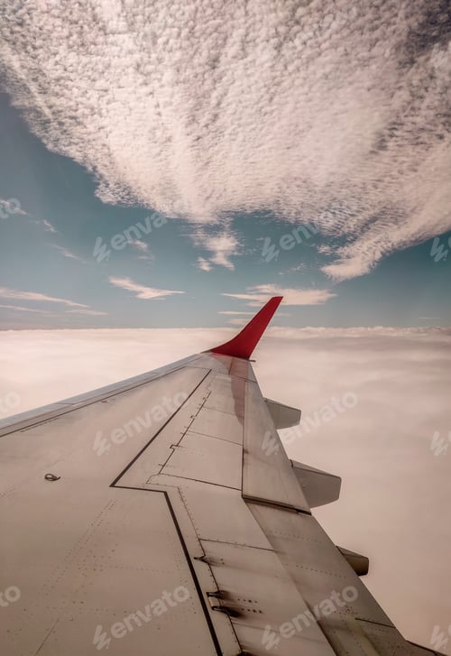 Preview: A Vertical Shot Of A White Airplane Wing With Red Design Under A Clam And Beautiful Sky
