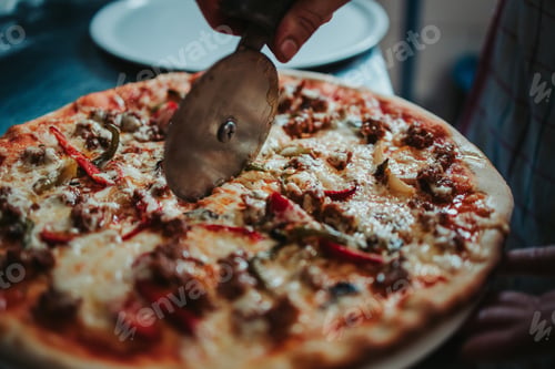 Preview: A Closeup Shot Of The Chef Cutting The Delicious Cheesy Pizza