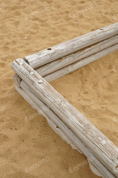 Preview: A High Angle Shot Of A Sandy Wavy Ground With Wooden Borders
