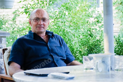 Preview: Tranquil Man In His 50S Sitting At The Table.