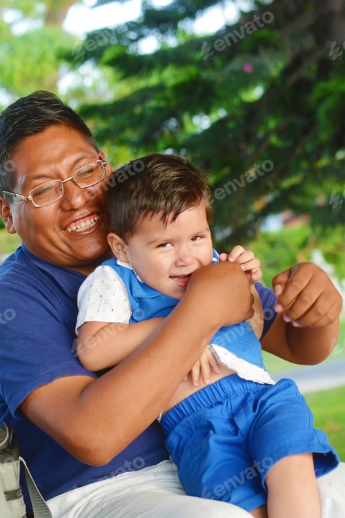 Preview: Portrait Of Native American Man With His Little Son In The Park.