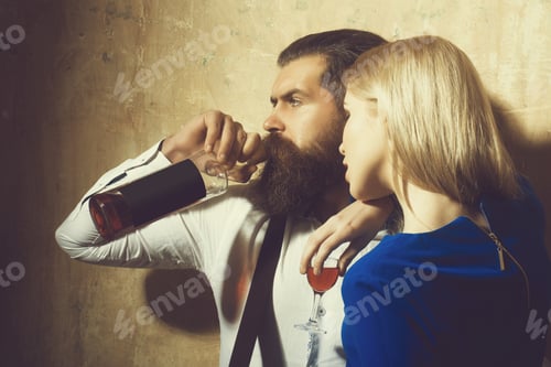 Preview: Couple In Love With Alcoholic Drinks. Girl With Glass Of Liqueur And Man Drinking Wine From Bottle