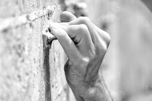 Preview: A Grayscale Shot Of A Person Climbing A Wall Under The Sunlight With A Blurry Backgrou