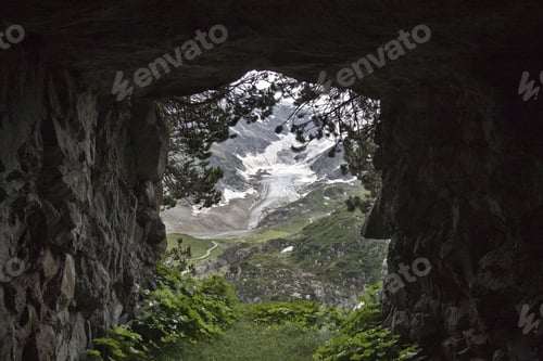 Preview: A View Of A Mountain Covered With Snow Seen From A Tunnel