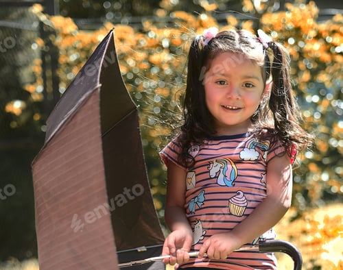 Preview: A Cute Smiling Caucasian Little Girl Holding An Umbrella On A Sunny Day