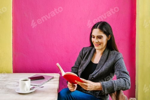 Preview: Mexican Woman Reading A Book In A Coffee Shop Terrace In A Colonial City Of Latin America