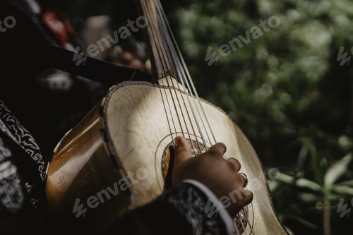 Preview: A Horizontal Shot Of A Acoustic Beige Guitar Played On By A Man