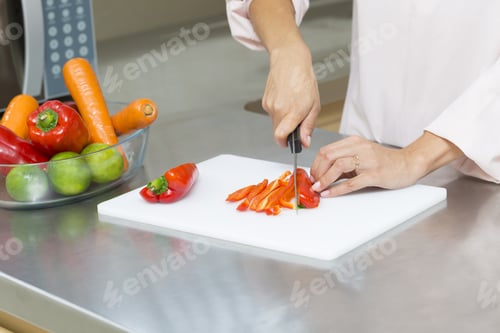 Preview: Closeup On Woman Cutting Fresh Vegetables In Kitchen