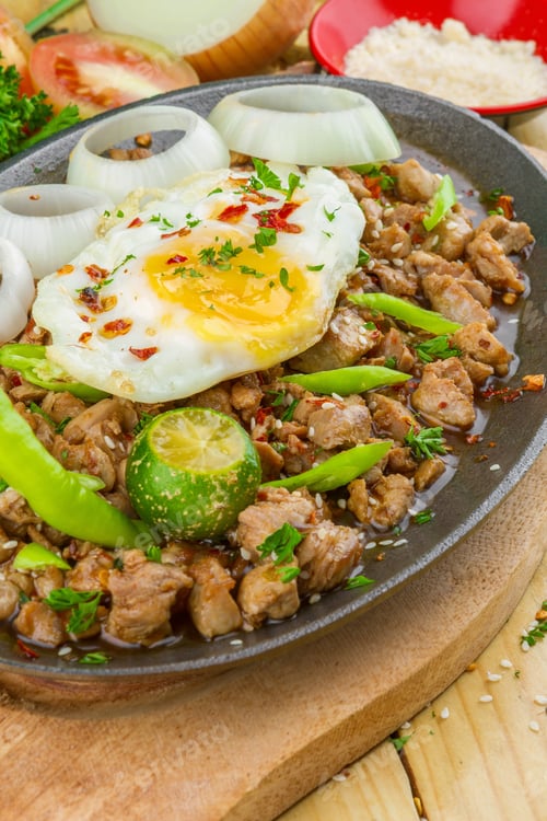 Preview: A Hot Meat Dish With Cut Onion, Omelet And Pepper Served On A Black Oval Bowl