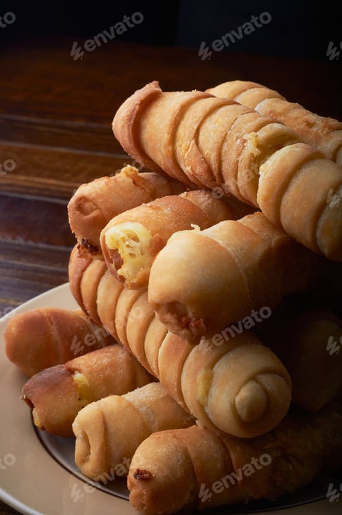 Preview: A Vertical Selective Focus Shot Of Corndogs In A Plate With A Dark Background