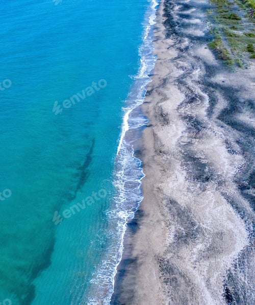 Preview: A High Angle Aerial Shot Of A Beautiful Blue Water Beach Waves Hitting The Shore