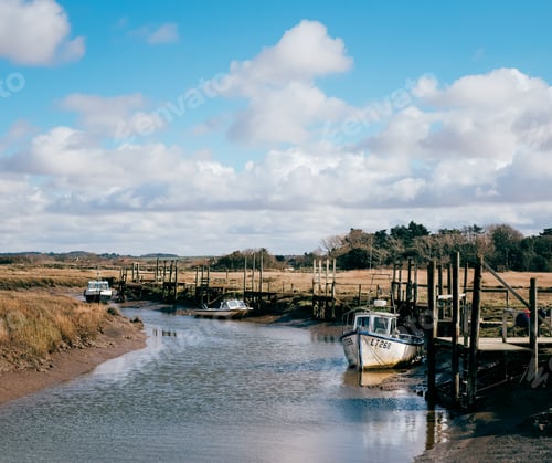 Preview: A Shot Of Several Boats Docked By The Riverbank