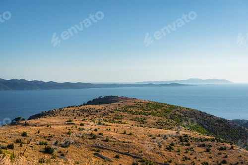 Preview: The Landscape View Of The Hills On The Shore Of A Calm Lake Under The Blue Sky