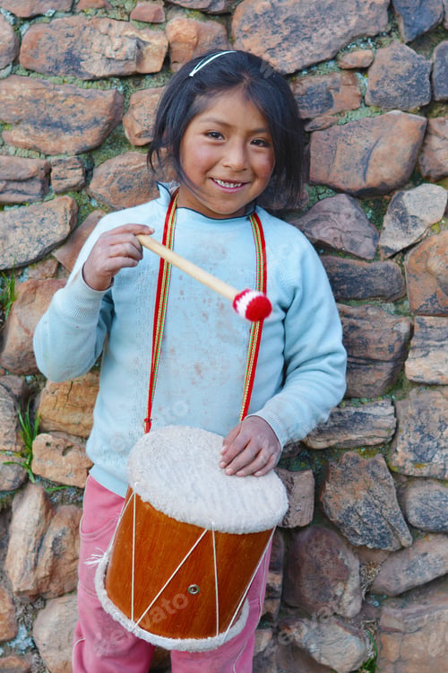 Preview: Little Native American Girl Playing Traditional Sikuri Drum.