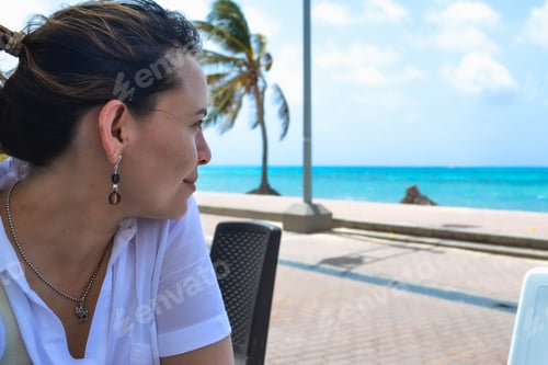 Preview: A Closeup Shot Of A Woman Smiling While Enjoying The View Of The Ocean