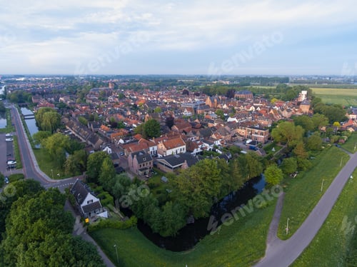 Preview: A Cityscape Of Vianen Covered In Buildings And Greenery Under A Cloudy Sky At Daytime In The