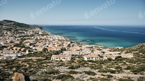 Preview: A Wide Shot Of Buildings Near The Sea Under A Blue Sky At Daytime