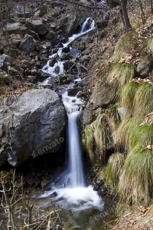Preview: A Vertical Shot Of A Beautiful Waterfall In The Forest
