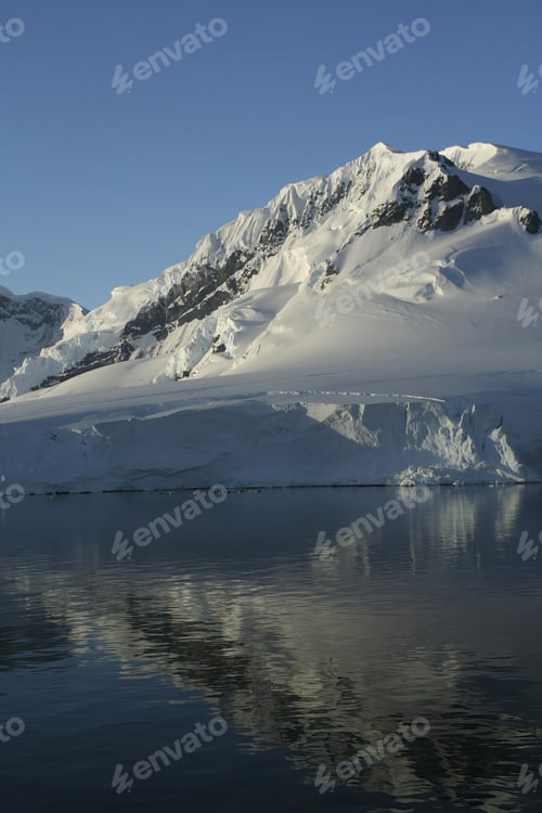 Preview: A Vertical Shot Of Mountains And Glaciers Reflected In Calm Ocean In Paradise Harbor, Antarctica