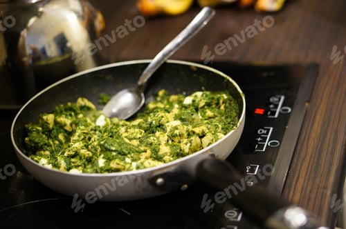 Preview: An Image Of Cooking A Spinach Dish In A Pan