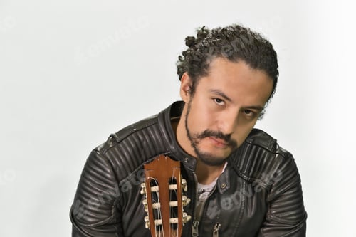 Preview: Portrait Of Attractive Latin Young In Rocker Jacket, On White Background, With Acoustic Guitar