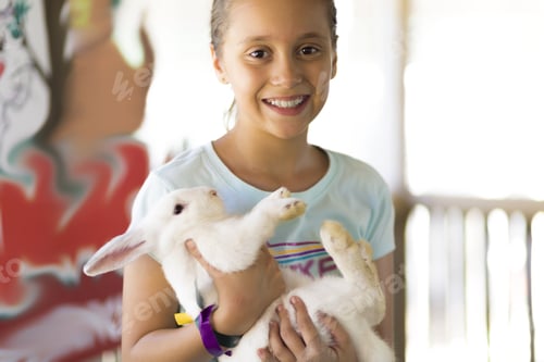 Preview: Happy Girl Playing With Rabbit In The Farm
