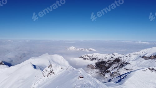 Preview: A Breathtaking Shot Of Peak Of Snowy Alps Covered By Clouds