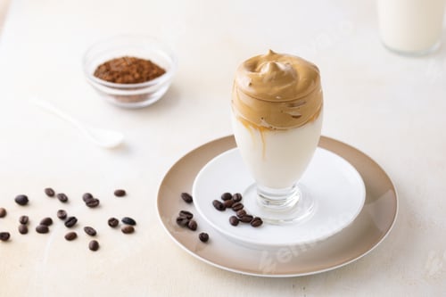 Preview: A Soft Focus Of Dalgona Coffee Topped With Chocolate Chips And A Cinnamon Stick