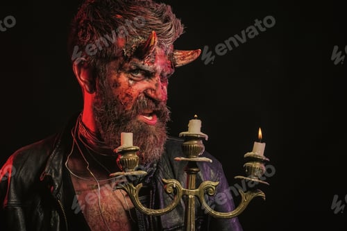 Preview: Halloween Flesh, Soul, Darkness, Light Concept. Man Demon Hold Candlestick On Black Background