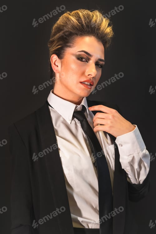 Preview: A Sexy Young Blonde Hair Female In A Black Suit Posing At Camera