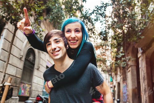 Preview: Happy Young Couple In Love Pointing Up On The Street