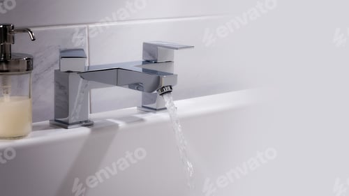 Preview: A Closeup Shot Of Water Flowing From A Basin Mixer Tap In The Bathroom