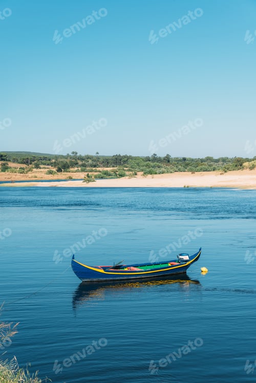 Preview: A Vertical Shot Of A Boat Sailing In A Lake In Constancia, Portugal