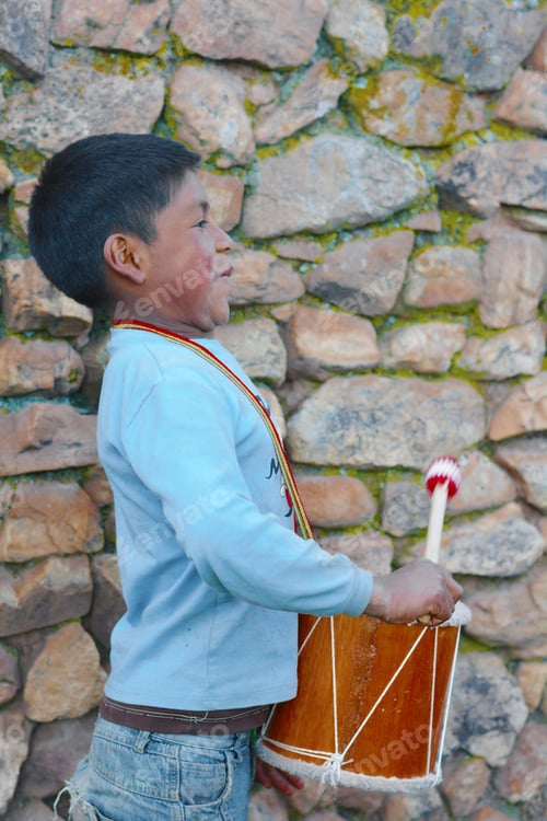 Preview: Little Native American Boy Playing Traditional Sikuri Drum.