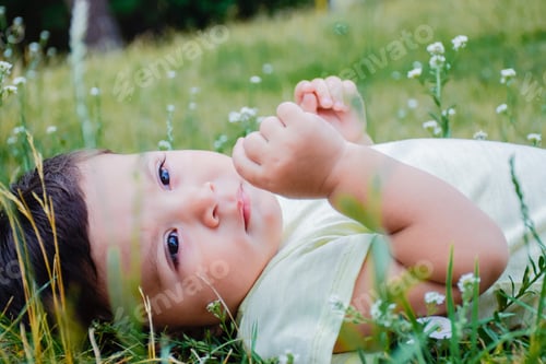 Preview: Little Latin Boy Laying On The Grass.