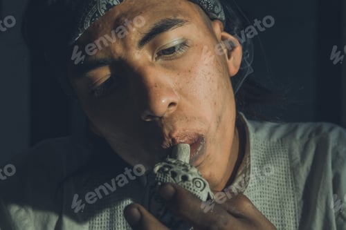 Preview: Portrait Of Latin Man Smoking Pot Looking To The Right