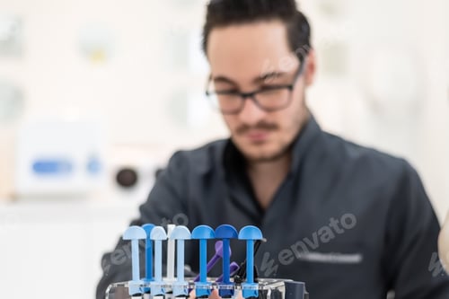 Preview: Professional Male In A Clinic Holding Dental Instruments