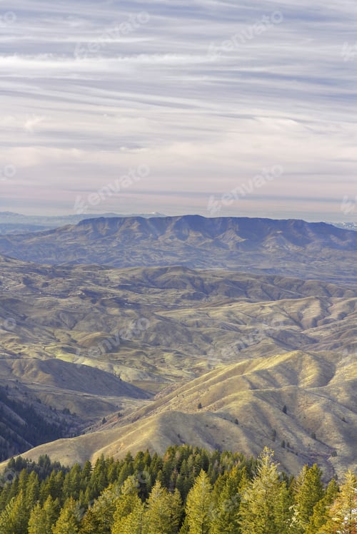 Preview: A Vertical Aerial Shot Of The Beautiful Mountains And Trees Under The Cloudy Sky