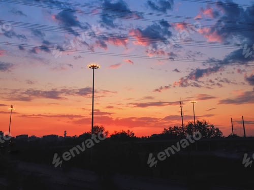 Preview: A Beautiful Scenery Of The Sunset Sky With Colorful Clouds Over A Cityscape