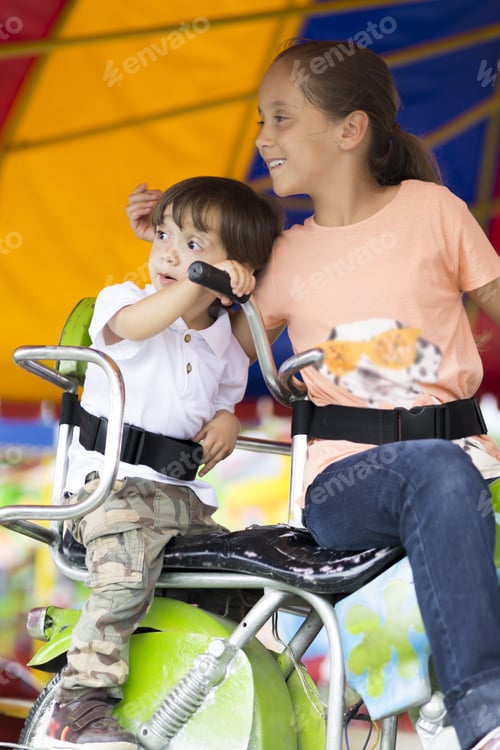 Preview: Happy Children Having Fun Riding On Carnival Carousel
